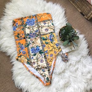 Out from under strapless cutout onepiece swimsuit